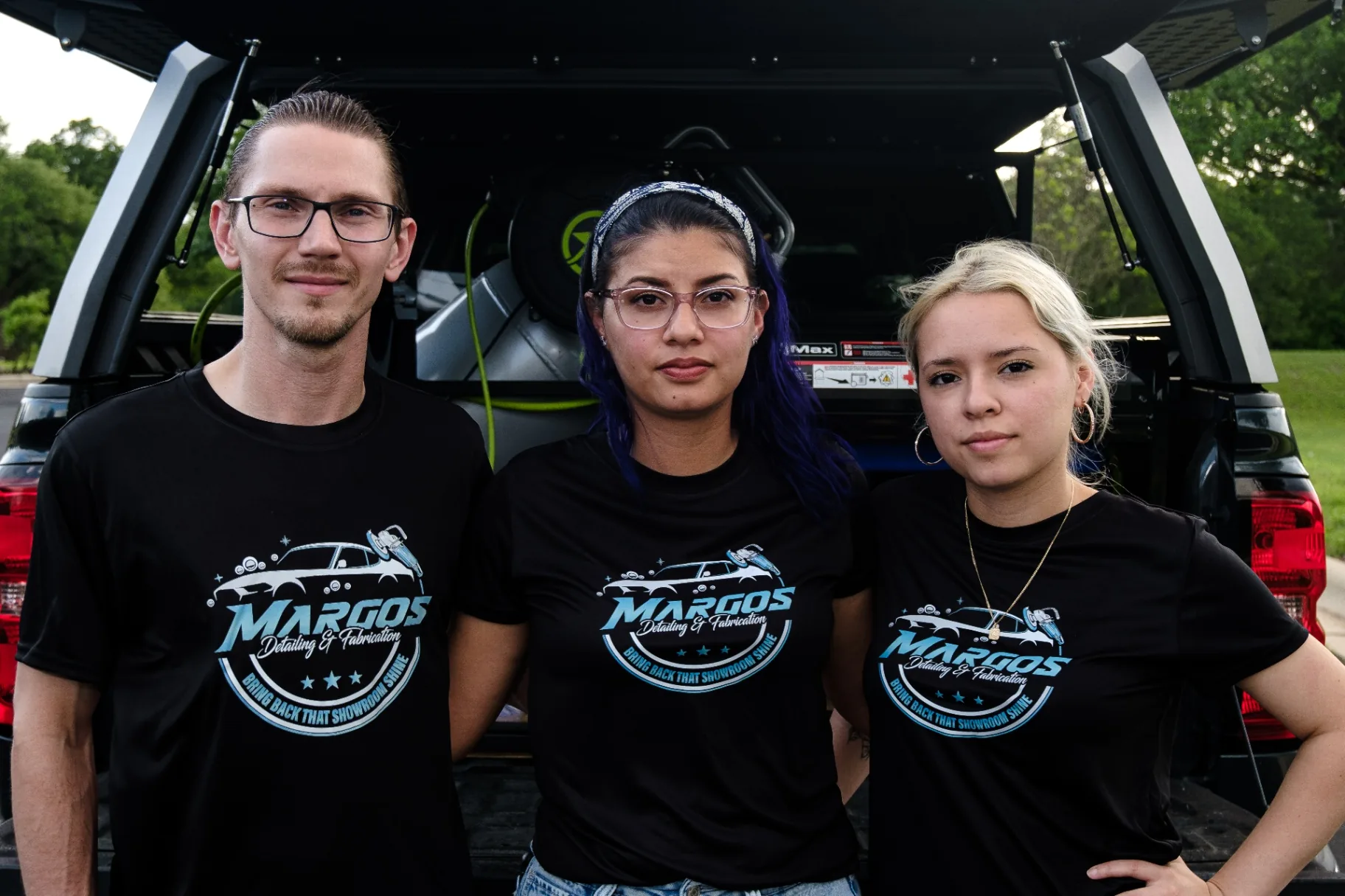 The Margos Detailing & Fabrication team posing at the back of the work truck